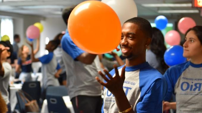 Trio student holding a balloon