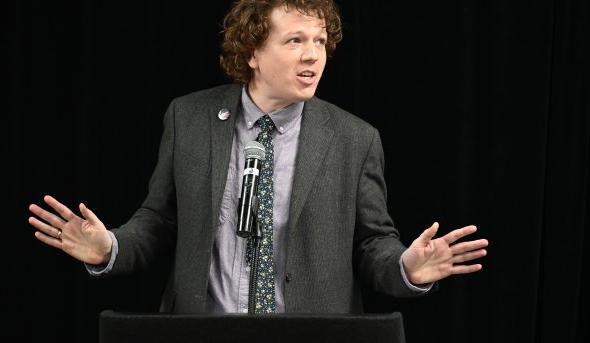 a man stands at a lectern